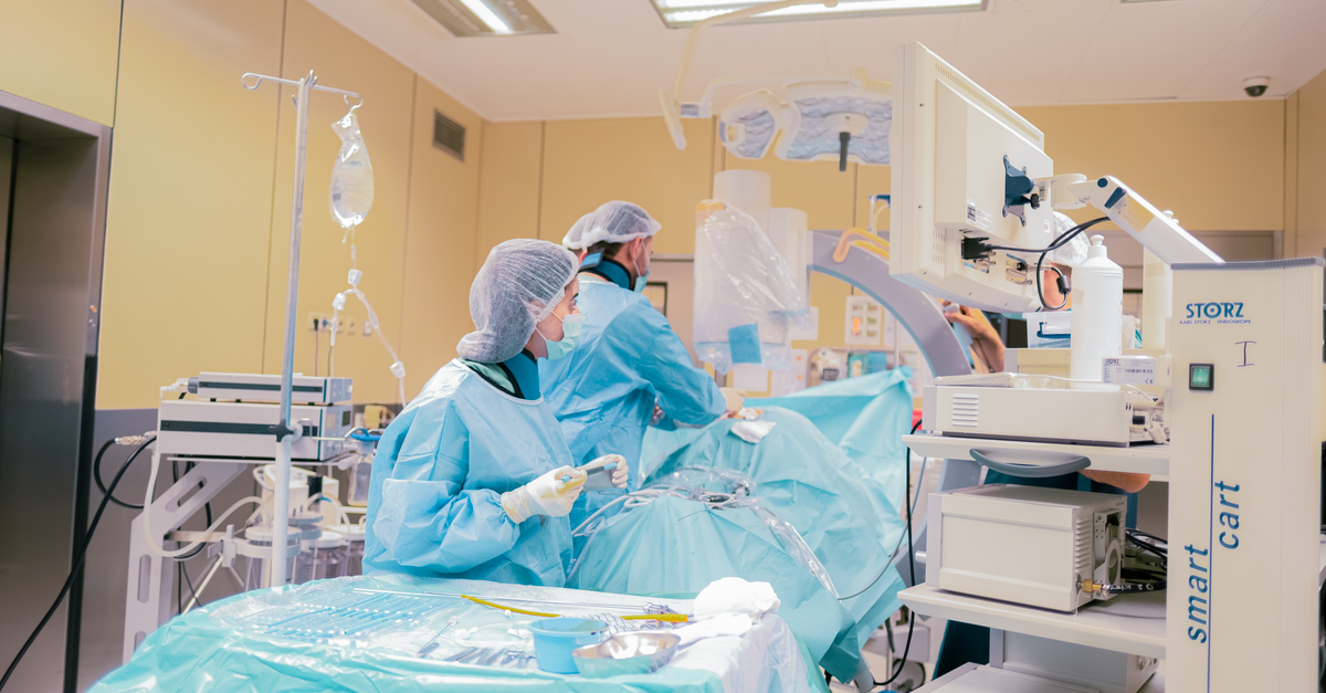 Surgical team in Baku, Azerbaijan operating room with advanced equipment and sterile environment.