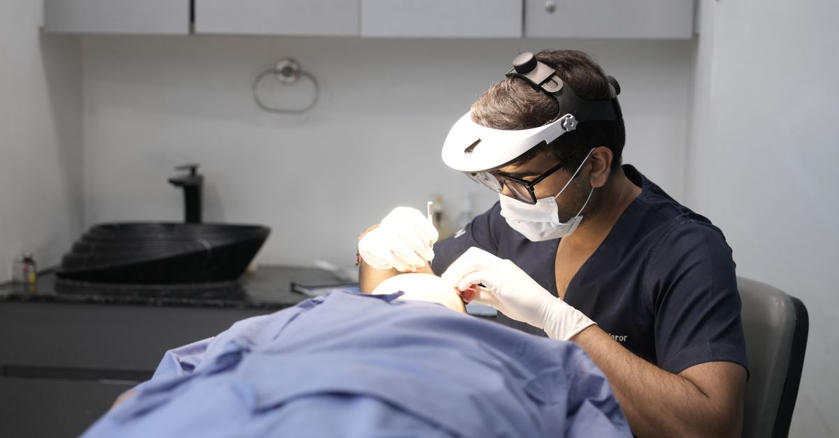 A dermatologist conducts a skin treatment on a patient in a modern clinic setting.