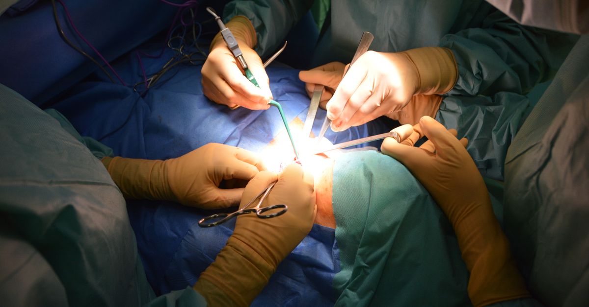 Close-up view of surgeons in an operating room performing a surgery with precision.